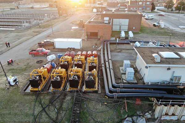 Yellow machinery, pipes, and buildings at Richmond WWTP