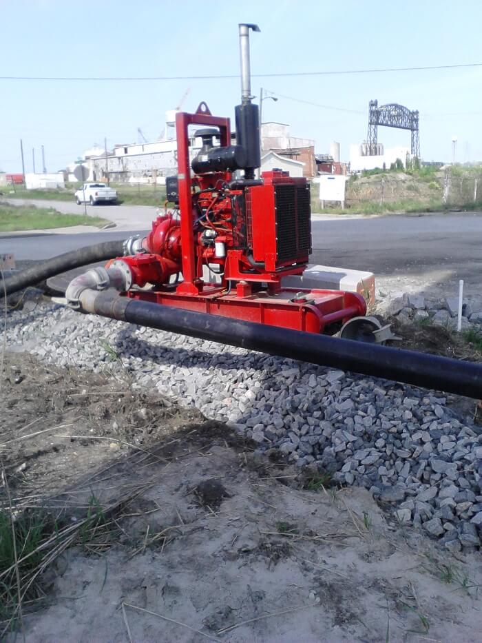 Water equipment rental. red pump at a construction site.